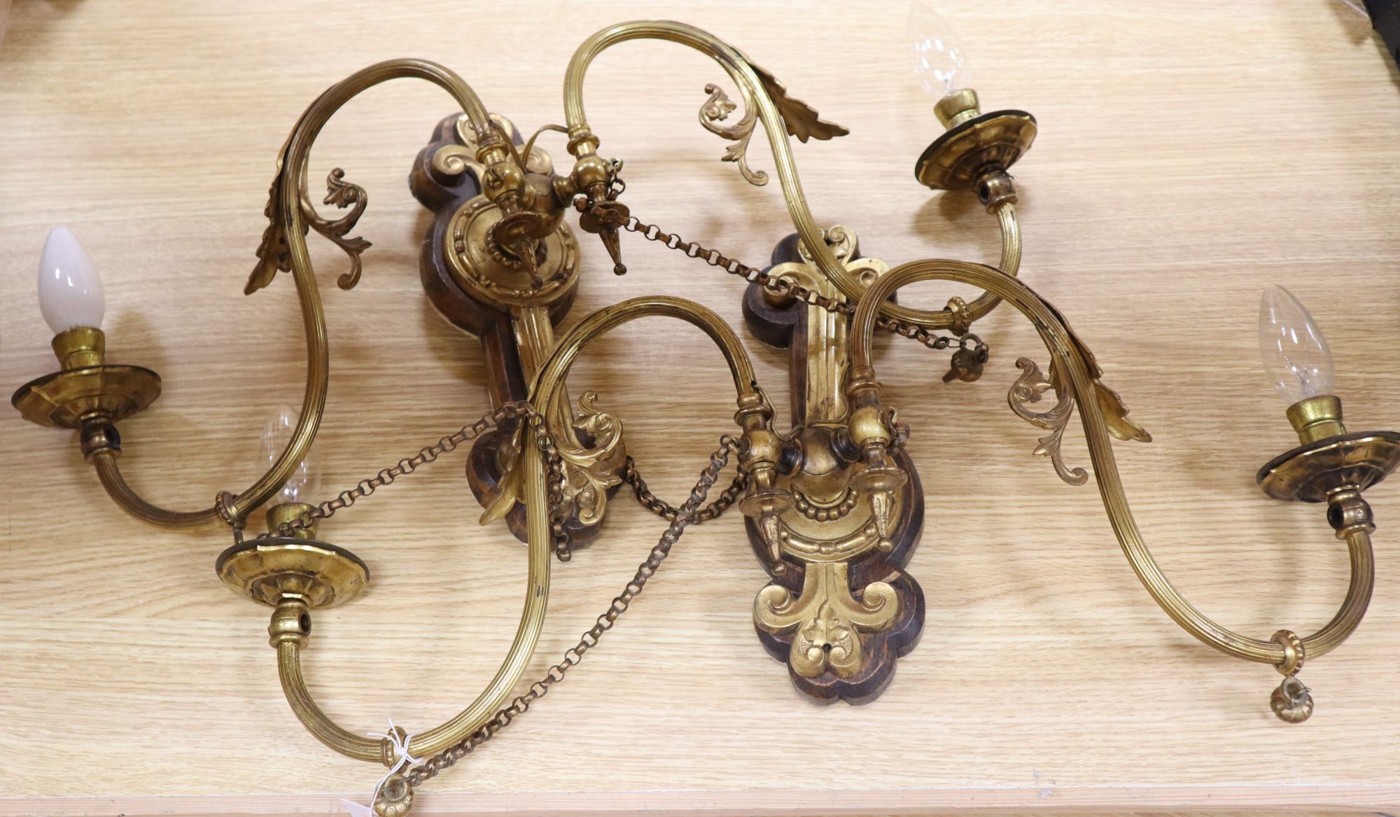 A pair of ormolu wall lights, width 65cm